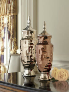 a pair of urns in copper and bronze colors