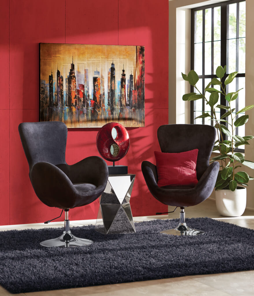 Modern setting with two black chairs, a mirrored side table with a red sculpture, cityscape wall art, and a black shag rug.