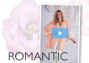 ROMANTIC, a video with a blonde woman in a coral top and cape-like jacket with crochet and fringe trim, and white pant.