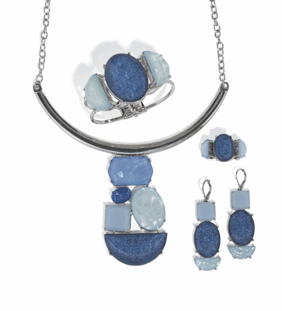 A artistic jewelry set in silver with dark and light blue stones, including a necklace, bracelet, ring and drop earrings.