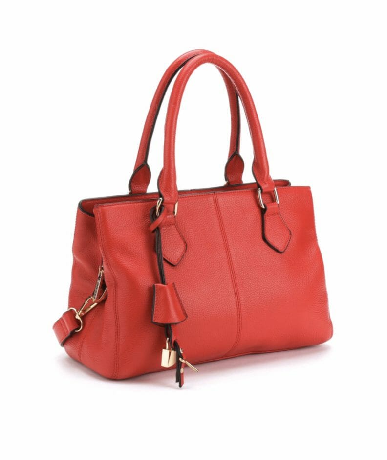 A deep coral faux leather bag with handles and shoulder strap, and a gold lock and key.