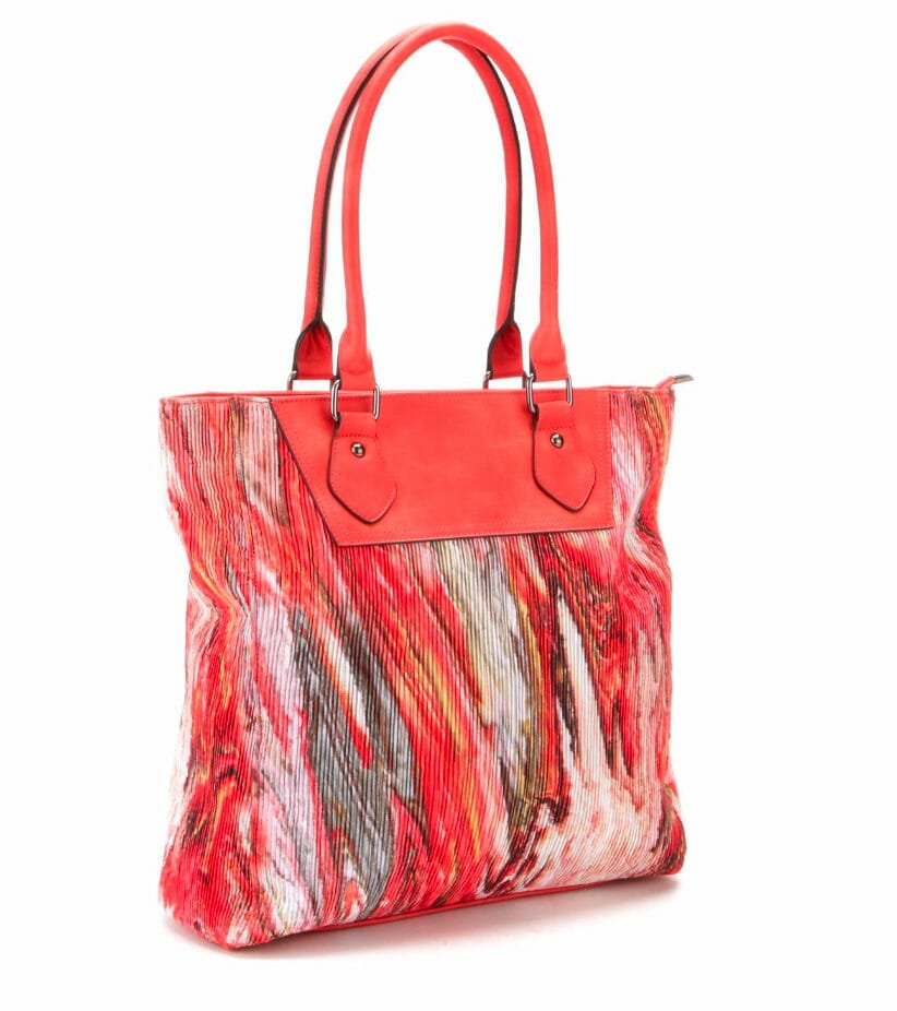 A finely quilted tote in a swirled marble-like coral, white, and brown print, with faux leather coral handles and top.