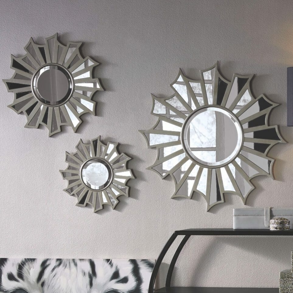 A set of three sizes of starburst wall mirrors with center round beveled mirrors, and radiating mirror sections.