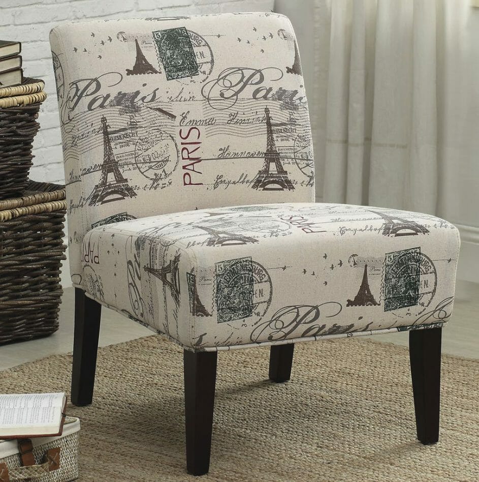 An armless chair with an upholstered seat and back, with a Paris themed print including the Eiffel Tower.