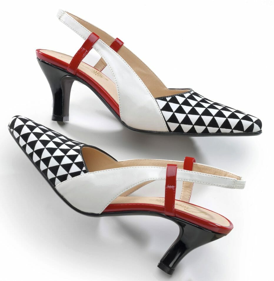 A black, red, and white pump with an open heel and side, with the toe in a black and white triangle pattern.