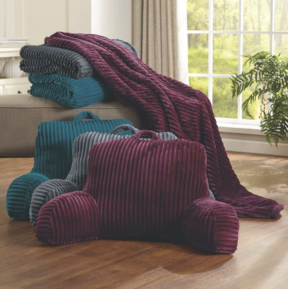 Three sets of a ribbed backrest pillow and matching throw, in magenta, gray, and teal blue.