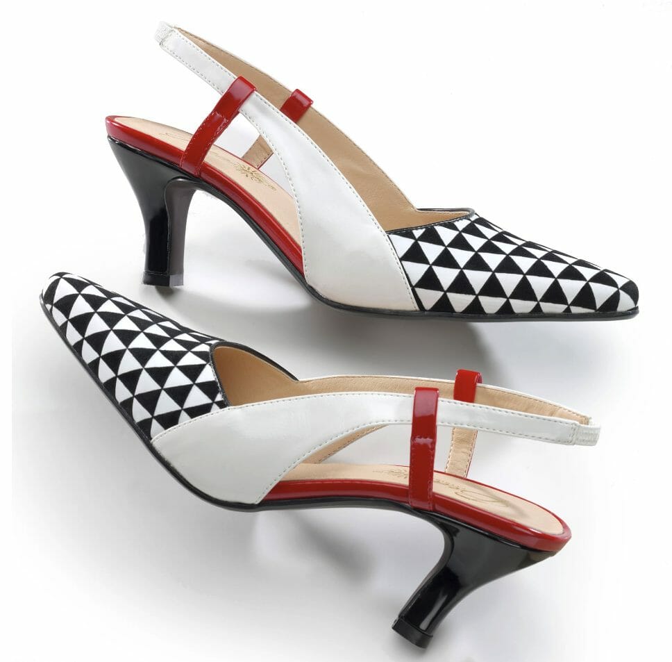 A black, red, and white pump with an open heel and side, with the toe in a black and white triangle pattern.