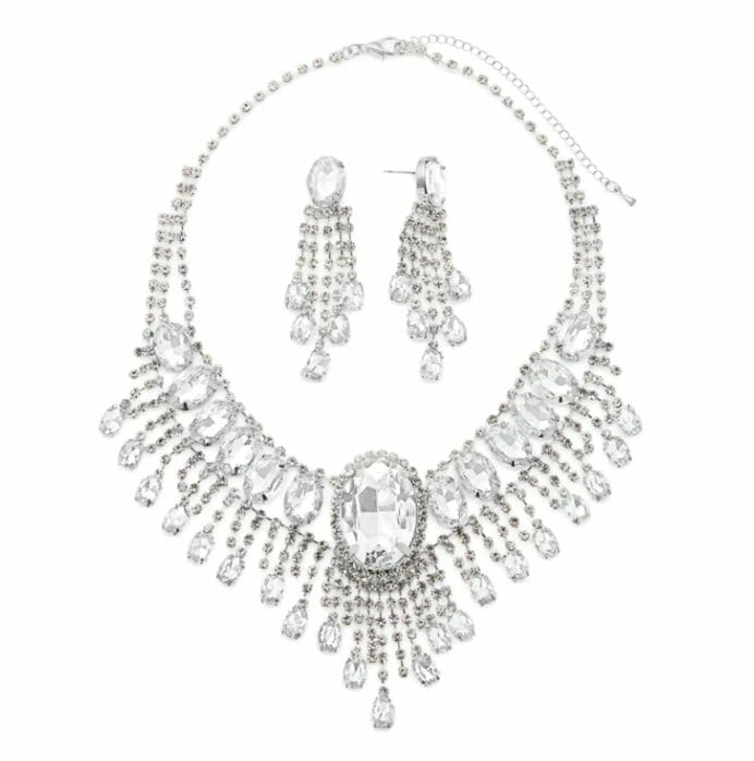 A crystal two-tier necklace with a large center pendant and dangling prisms, with matching crystal drop earrings. 