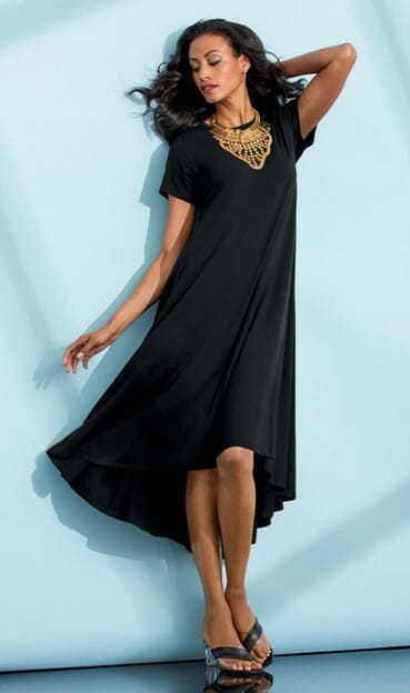 Woman wearing the black gigi high low dress with a gold chunky necklace